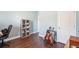 Bedroom area with hardwood flooring, a bookshelf, and instruments against the wall at 1601 Thin Pine Dr, Johns Island, SC 29455