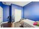 This is a bedroom with blue walls, dark hardwood flooring, and a closet at 1601 Thin Pine Dr, Johns Island, SC 29455