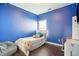 Bright blue bedroom featuring hardwood floors, a comfortable beanbag chair, and natural lighting at 1601 Thin Pine Dr, Johns Island, SC 29455