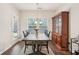 Bright dining room with hardwood floors, an antique hutch, and a view of the outdoor patio at 1601 Thin Pine Dr, Johns Island, SC 29455