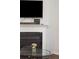 Close-up view of the living room fireplace with glass coffee table and decorative accents at 1601 Thin Pine Dr, Johns Island, SC 29455