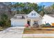 Charming one-story home with a well-manicured lawn and a welcoming front porch at 1601 Thin Pine Dr, Johns Island, SC 29455