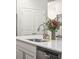 Bright kitchen featuring a stainless steel faucet, white cabinets, granite countertops, and a view of the patio doors at 1601 Thin Pine Dr, Johns Island, SC 29455