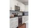 Stylish kitchen showcasing stainless steel appliances, white cabinetry, and attractive backsplash at 1601 Thin Pine Dr, Johns Island, SC 29455