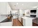 Open-concept kitchen with white cabinets, stainless steel appliances, and a breakfast bar at 1601 Thin Pine Dr, Johns Island, SC 29455