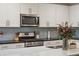 Well-equipped kitchen with stainless steel appliances, white cabinets, and a center island at 1601 Thin Pine Dr, Johns Island, SC 29455