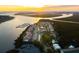 Gorgeous sunset aerial view of harbor side condominiums, docks, and waterway at 166 W Mariners Cay Dr, Folly Beach, SC 29439