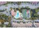 Scenic aerial view of community amenities including a pool, tennis court, ponds, boat parking, and clubhouse at 166 W Mariners Cay Dr, Folly Beach, SC 29439