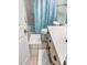 Bathroom with a tiled floor, toilet, shower with a light blue tropical-themed curtain and a wood vanity at 166 W Mariners Cay Dr, Folly Beach, SC 29439