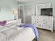 Bright bedroom featuring a queen bed, a white dresser with a TV and an abundance of natural light at 166 W Mariners Cay Dr, Folly Beach, SC 29439