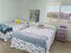 Guest bedroom with two twin beds featuring fish themed decor and comfy, casual furnishings at 166 W Mariners Cay Dr, Folly Beach, SC 29439