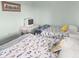 Guest bedroom with twin beds, casual fish decor, and a charming vintage-style TV setup at 166 W Mariners Cay Dr, Folly Beach, SC 29439