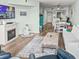 Comfortable living room with fireplace, TV, and view into kitchen at 166 W Mariners Cay Dr, Folly Beach, SC 29439
