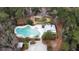 Aerial view of community pool, clubhouse, picnic area, and playground in wooded neighborhood at 1847 Grovehurst Drive, Charleston, SC 29414