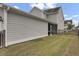 A view of the side yard, showing the house, screened-in porch, and lawn at 1847 Grovehurst Drive, Charleston, SC 29414