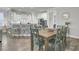 A dining area with a wooden table and seating adjacent to a modern kitchen space at 1847 Grovehurst Drive, Charleston, SC 29414