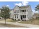 Charming two-story home with a double porch, gray siding, black shutters, and manicured landscaping at 1847 Grovehurst Drive, Charleston, SC 29414