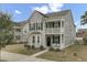 Charming two-story home with a double porch, gray siding, black shutters, and manicured landscaping at 1847 Grovehurst Drive, Charleston, SC 29414