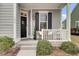 Inviting front porch features a seating area, lantern lighting, and manicured greenery at 1847 Grovehurst Drive, Charleston, SC 29414