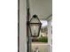 Close-up of a gas lantern on a front porch with seating area at 1847 Grovehurst Drive, Charleston, SC 29414