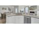 An open concept kitchen featuring a breakfast bar, stainless steel appliances, and dining area at 1847 Grovehurst Drive, Charleston, SC 29414