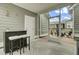 Relaxing screened porch with bar and stool seating that looks out over a patio set at 1847 Grovehurst Drive, Charleston, SC 29414