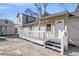 Back exterior view featuring a deck, white railing, and a shed-like structure in the background at 1987 Echo Ave, North Charleston, SC 29405