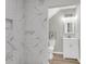 Updated bathroom with white marble-style tile in the shower and modern vanity at 1987 Echo Ave, North Charleston, SC 29405