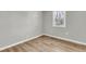 Bright bedroom features a window and new light-colored wood flooring at 1987 Echo Ave, North Charleston, SC 29405