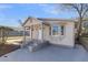 Charming home with a covered porch, neutral siding, and gray painted steps leading to the front door at 1987 Echo Ave, North Charleston, SC 29405
