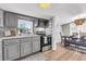 Remodeled kitchen offers gray cabinetry, stainless appliances, and ample natural light at 1987 Echo Ave, North Charleston, SC 29405