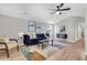 Bright living room with gray walls, recessed lighting, blue sofa and a modern area rug at 1987 Echo Ave, North Charleston, SC 29405