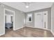 Open living room featuring wood floors, a ceiling fan, and a bright white entry door at 1987 Echo Ave, North Charleston, SC 29405