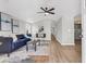 Bright living room with vaulted ceilings, wood floors, and stylish blue sofa at 1987 Echo Ave, North Charleston, SC 29405