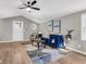 Open-concept living area with wood floors, vaulted ceiling, and a decorative blue velvet sofa at 1987 Echo Ave, North Charleston, SC 29405