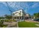 Charming building with outdoor seating, manicured lawn, and nearby parking, set under a beautiful blue sky at 2001 E Patterson Pt, Hanahan, SC 29410