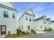 Row of pristine white two-story homes with well-manicured lawns and modern architectural design at 2001 E Patterson Pt, Hanahan, SC 29410
