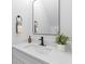 Modern bathroom features a white vanity with stone countertop, a black faucet, a black mirror, and tasteful decor at 2008 Emden St, North Charleston, SC 29406
