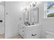 Bathroom features a double vanity, modern lighting, white cabinets, and stylish black fixtures at 2008 Emden St, North Charleston, SC 29406