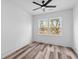 Clean, well-lit bedroom features wood-look floors, ceiling fan, and a bright window view at 2008 Emden St, North Charleston, SC 29406