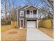 Charming two-story home with gray siding, a balcony and a well-maintained front yard and driveway at 2008 Emden St, North Charleston, SC 29406