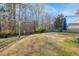 Expansive backyard with a swing set and mature trees, offering ample space for recreation at 218 Mayfield Dr, Goose Creek, SC 29445