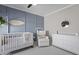 Sweet Bedroom featuring a crib, white dresser, decor and an accent wall panel at 218 Mayfield Dr, Goose Creek, SC 29445