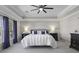 Spacious main bedroom features tray ceilings, natural light, and calm color scheme for a serene and welcoming atmosphere at 218 Mayfield Dr, Goose Creek, SC 29445