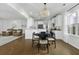 Open-concept dining area and kitchen with white cabinets, modern appliances, and hardwood floors at 218 Mayfield Dr, Goose Creek, SC 29445