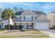 Charming two-story home with a well-manicured lawn and a welcoming front porch at 218 Mayfield Dr, Goose Creek, SC 29445