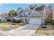 Two-story home with a well-manicured lawn, palm tree, driveway, and an attached two-car garage at 218 Mayfield Dr, Goose Creek, SC 29445