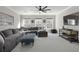 Spacious living room with large sectional sofa, ottoman, and natural light at 218 Mayfield Dr, Goose Creek, SC 29445