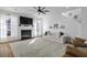 Cozy living room with a white sofa, fireplace, large rug, and ample natural light from the many windows at 218 Mayfield Dr, Goose Creek, SC 29445