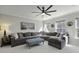 Bright living room featuring a large sectional sofa, ottoman, and sunny windows at 218 Mayfield Dr, Goose Creek, SC 29445